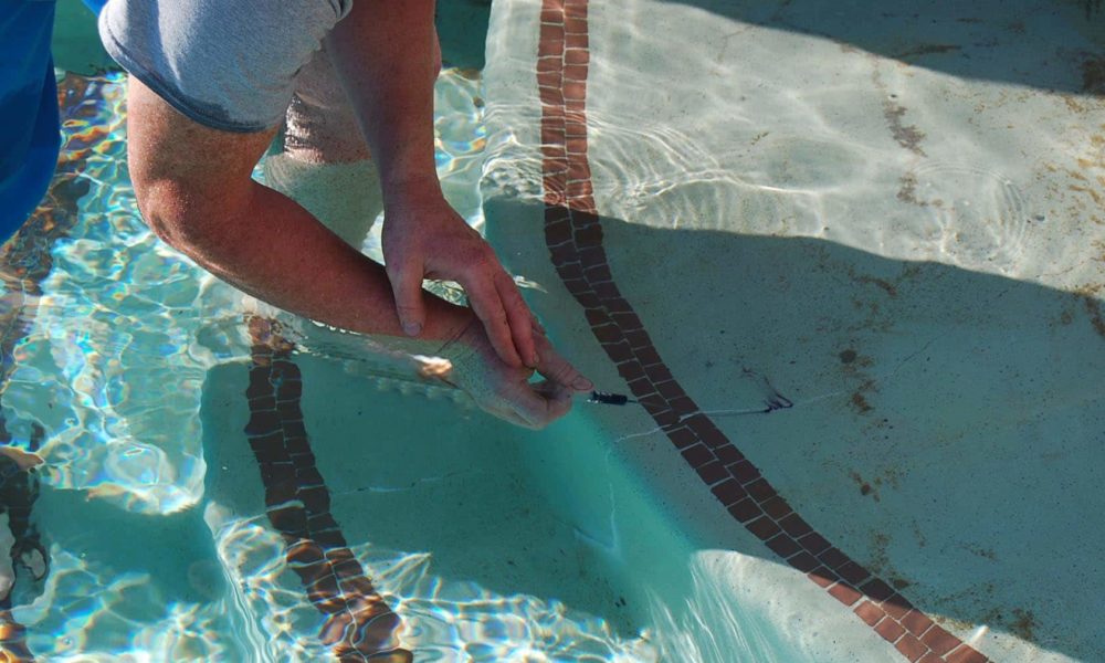 Technician performing leak detection on a swimming pool in Dallas, TX