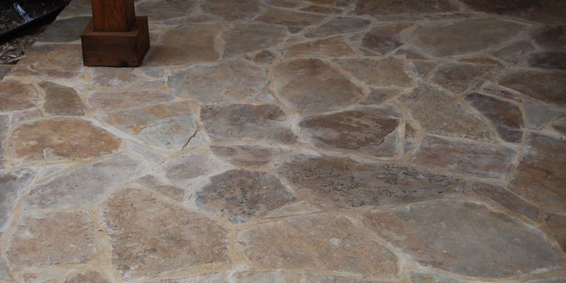 Natural stone patio designed and built by Leak-Tech in North Dallas